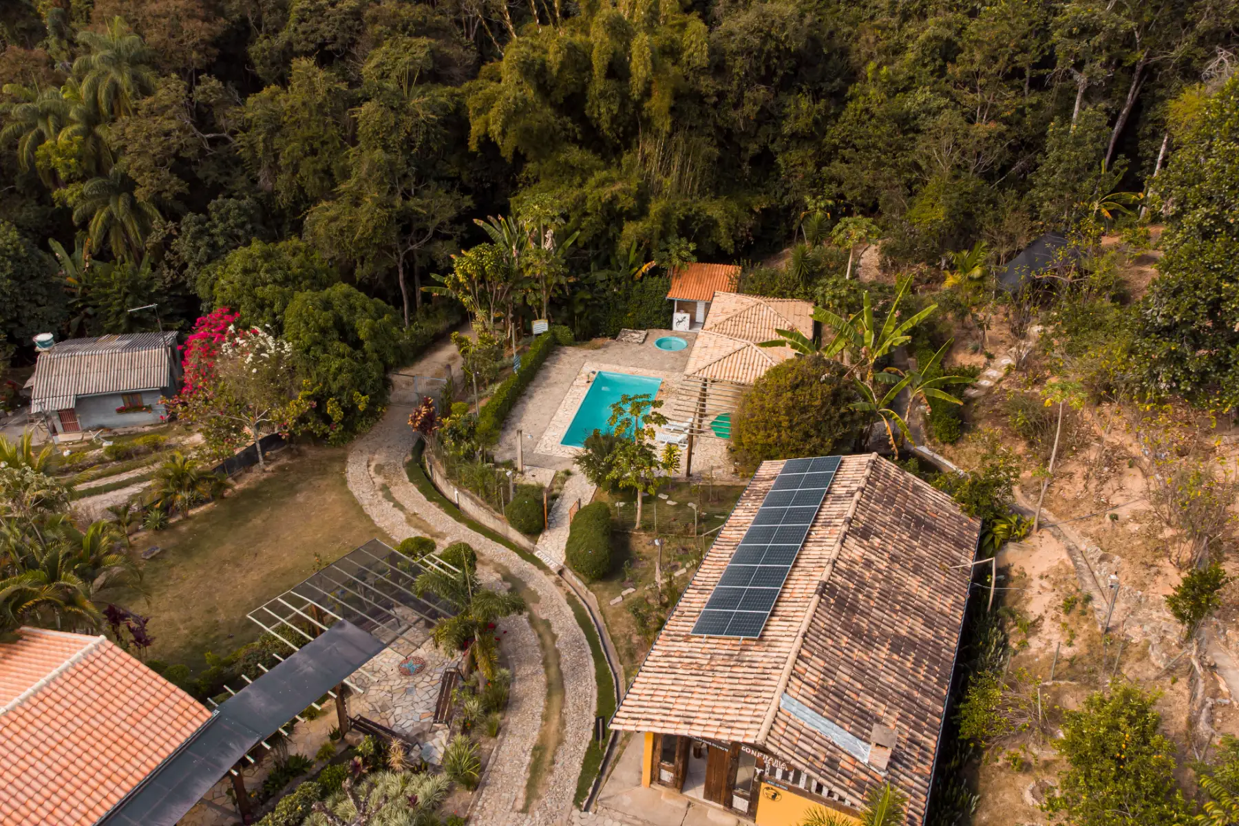 Vista aérea da piscina, da praça e da Confraria ao fim do dia